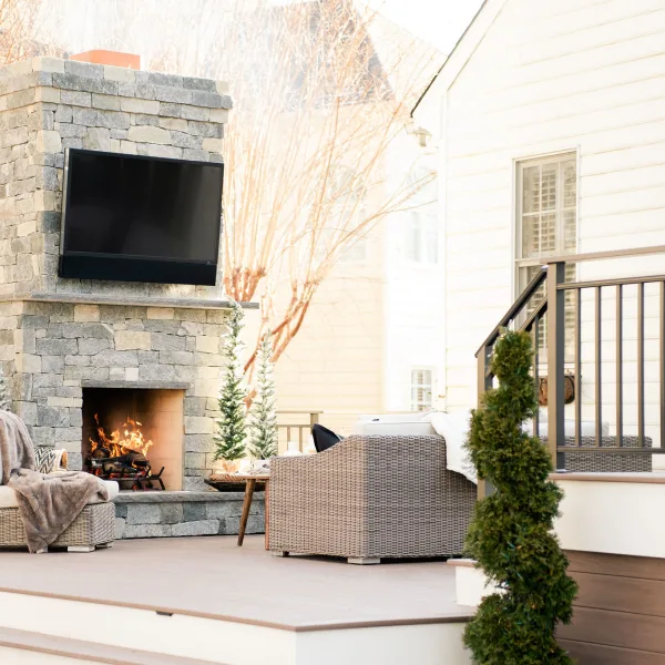 custom outdoor fireplace and tv with patio furniture