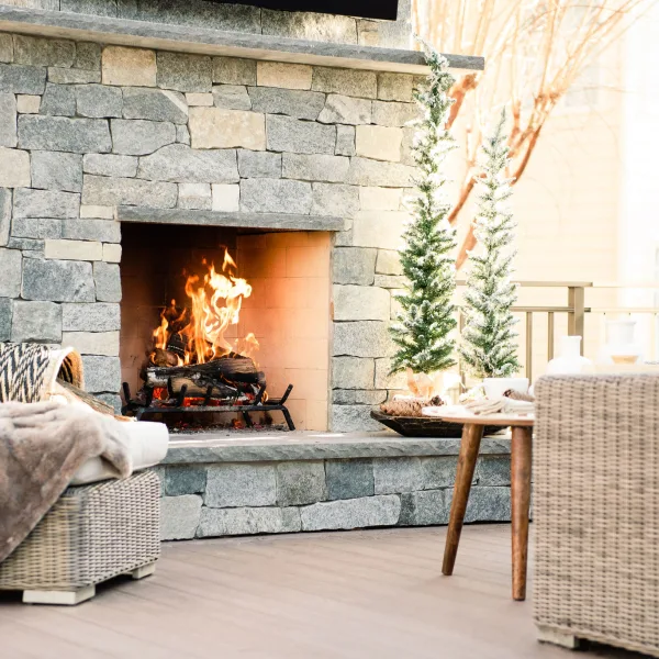 cozy outside custom stone fireplace