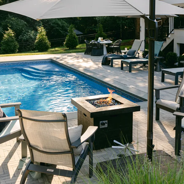 fiberglass swimming pool with concrete pavers