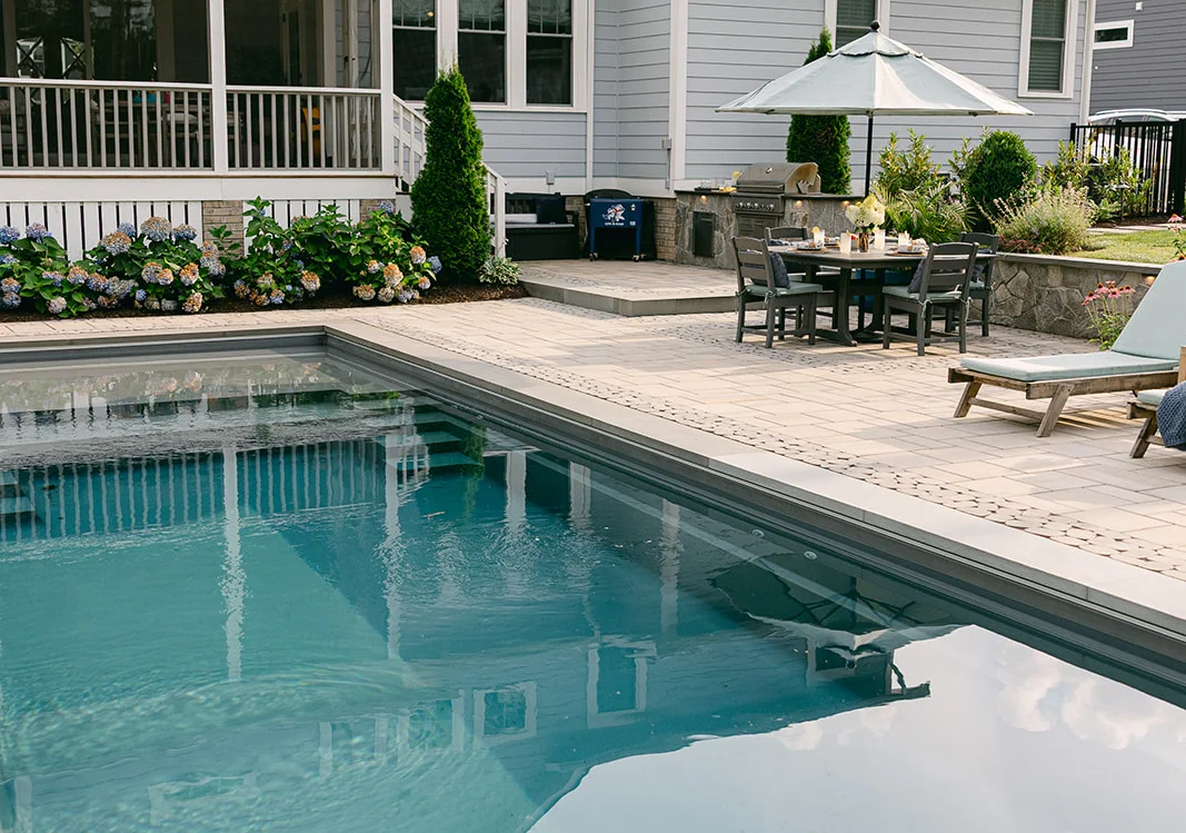 Christmas time outdoor living space in front of a stone fireplace