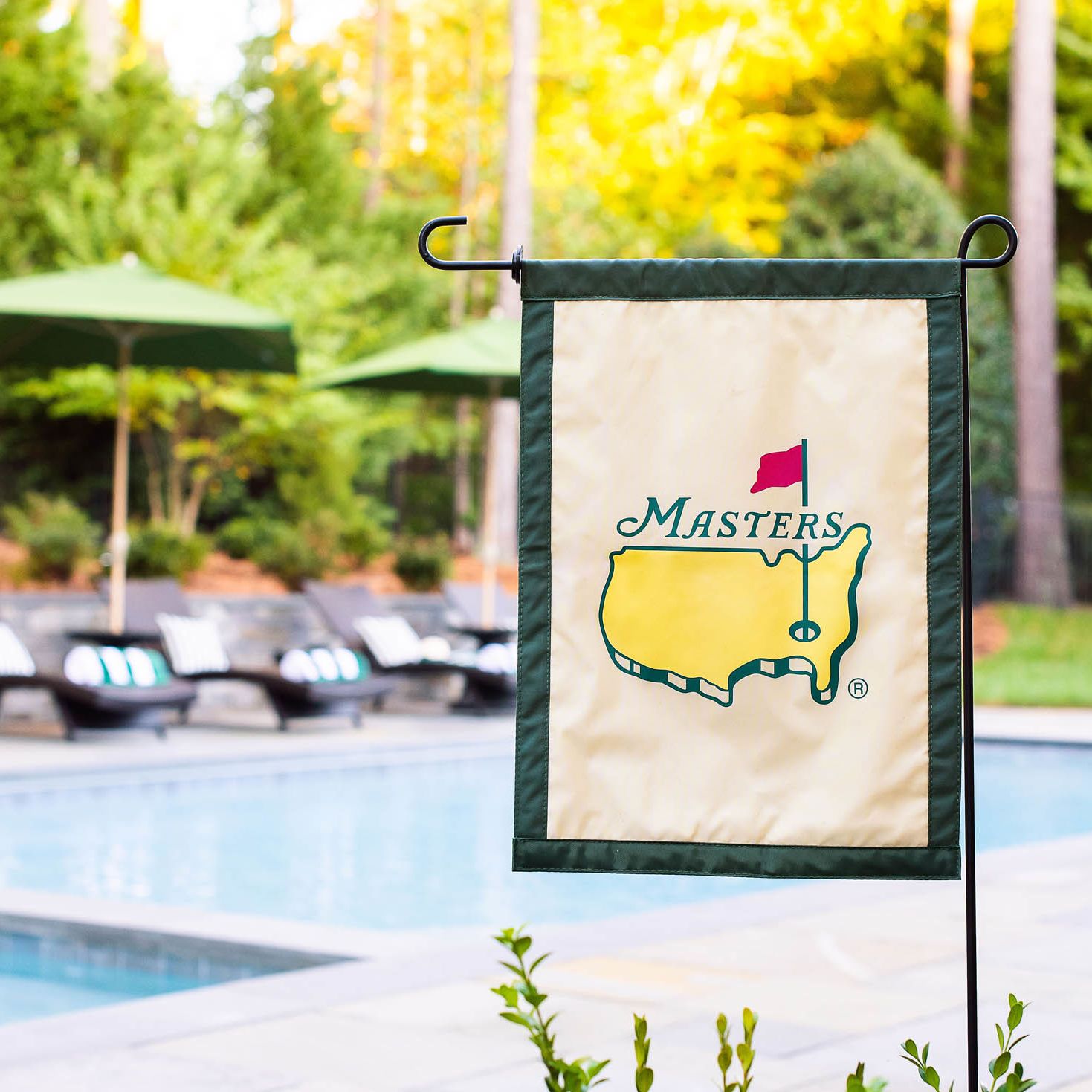 Masters lawn flag displayed in front of the backyard pool