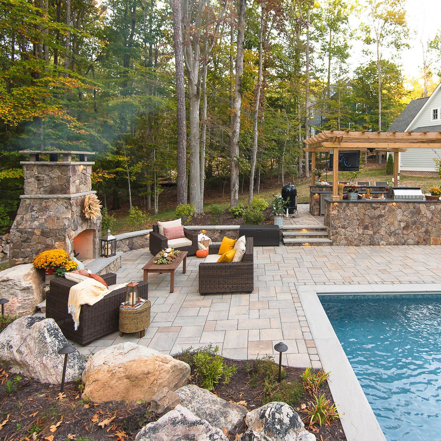 hardscape project with natural stone patio, wood pergola and fiberglass pool